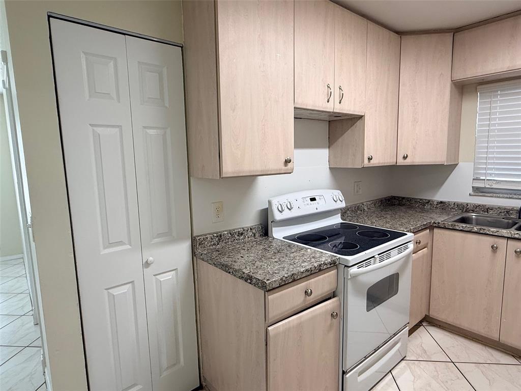 3704 36th Street West Bradenton, FL 34205 - Photo 8 of 34 a kitchen with white cabinets and white appliances
