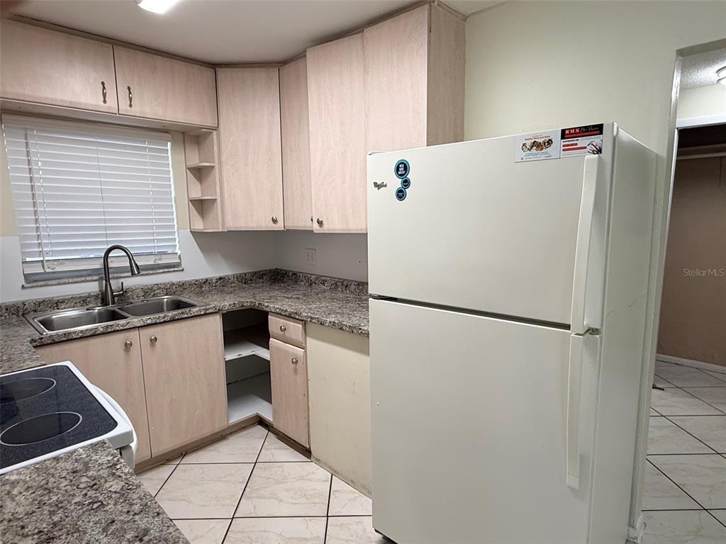 3704 36th Street West Bradenton, FL 34205 - Photo 9 of 34 a white refrigerator freezer sitting inside of a kitchen