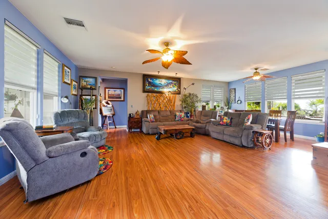 a living room with furniture fireplace and a large window