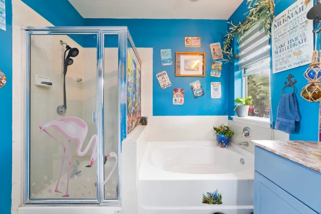 a bathroom with a bathtub a sink and a shower