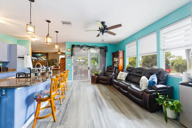 a living room with furniture a flat screen tv and a large window