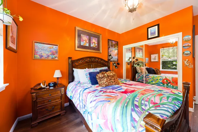 a bedroom with bed and wooden floor