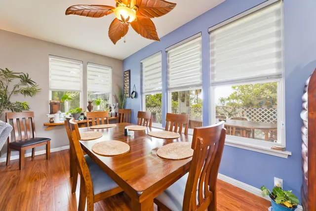 a dining room with furniture window and wooden floor