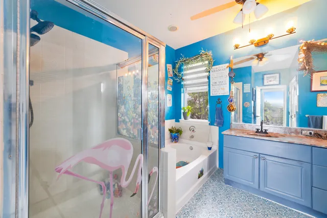 a bathroom with a tub sink and mirror