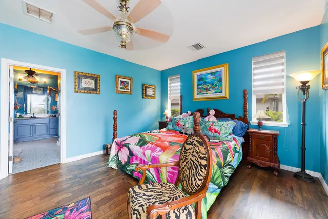 a bedroom with bed and wooden floor