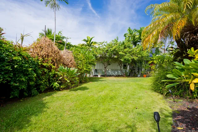 a yellow house with a yard