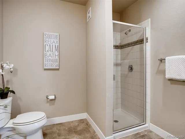 a bathroom with a shower toilet and sink