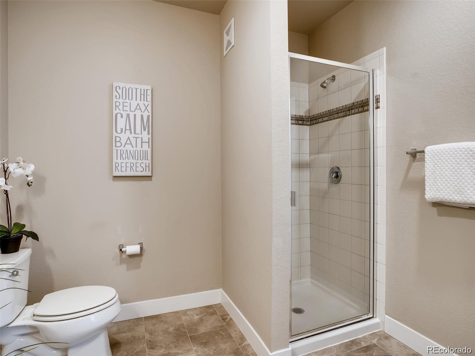 15274 West 64th Lane, Unit 107 Arvada, CO 80007 - Photo 15 of 24 a bathroom with a shower toilet and sink