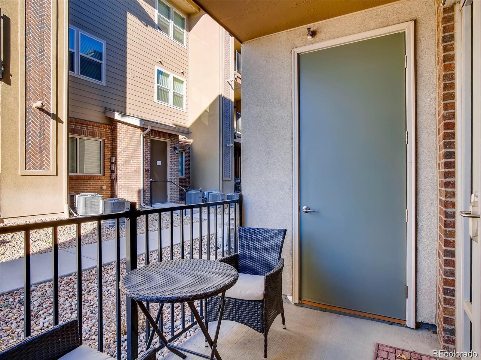 15274 West 64th Lane, Unit 107 Arvada, CO 80007 - Photo 19 of 24 a view of a chair and table in the balcony