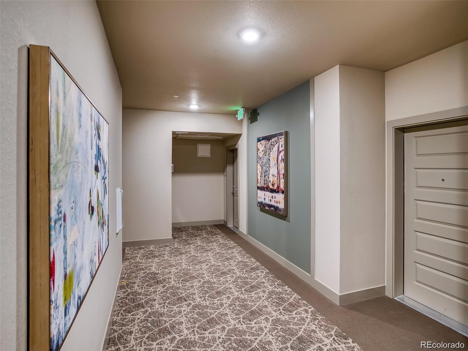 15274 West 64th Lane, Unit 107 Arvada, CO 80007 - Photo 20 of 24 a view of hallway with a hallway and stairs with wooden floor