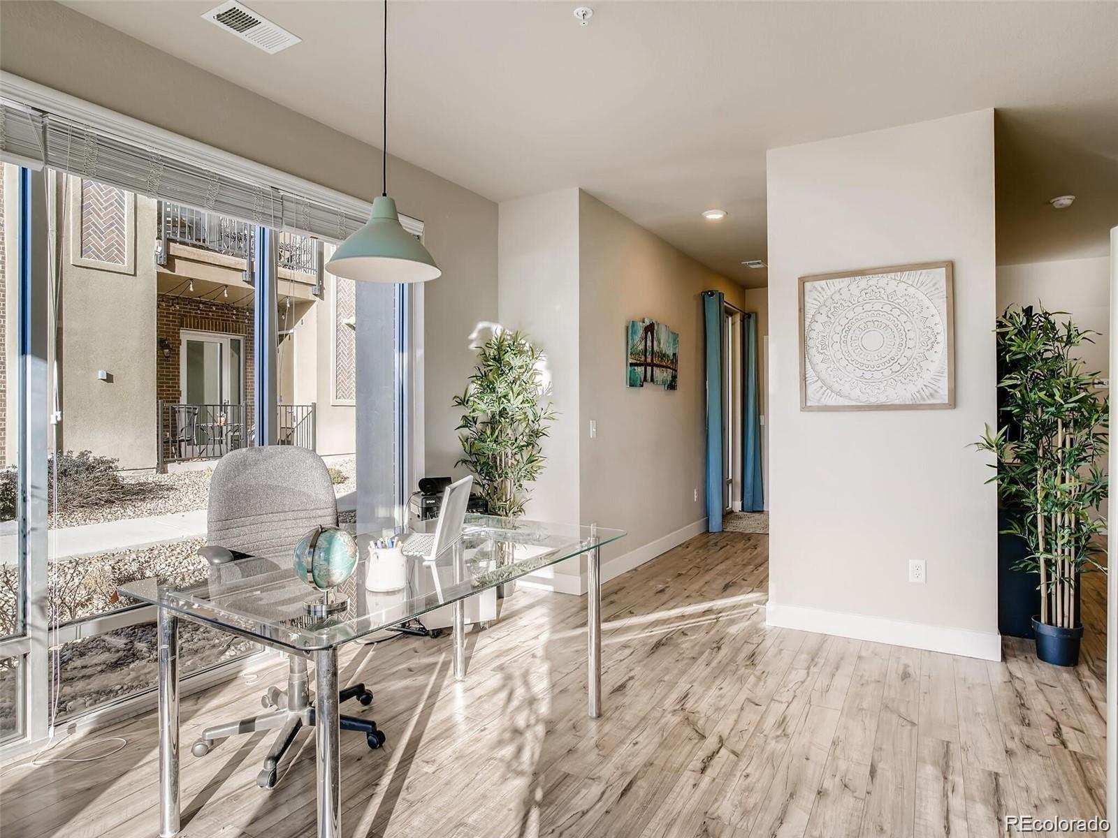 15274 West 64th Lane, Unit 107 Arvada, CO 80007 - Photo 2 of 24 a view of a livingroom with furniture and floor to ceiling window