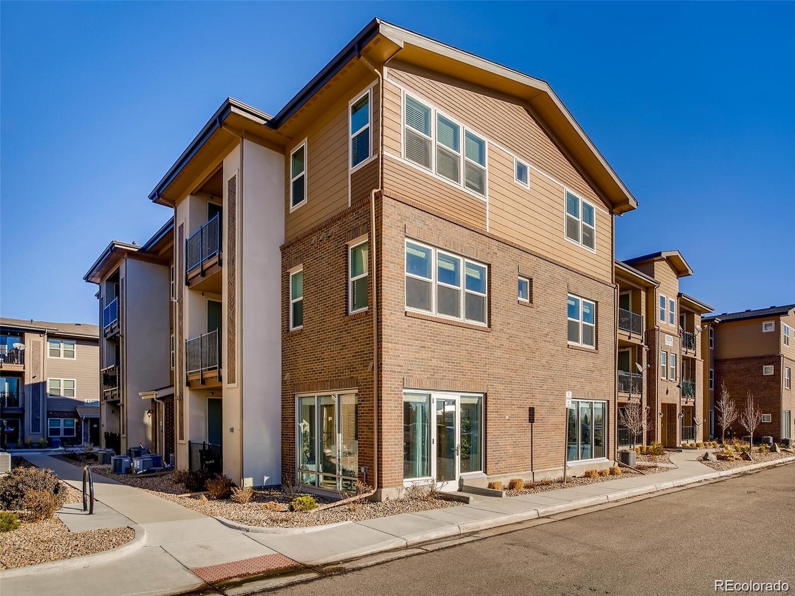 15274 West 64th Lane, Unit 107 Arvada, CO 80007 - Photo 22 of 24 a front view of a building with street