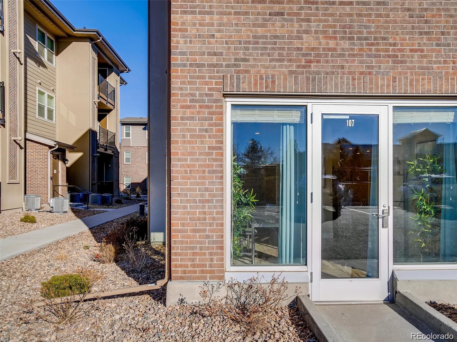 15274 West 64th Lane, Unit 107 Arvada, CO 80007 - Photo 24 of 24 a view of a house with a patio