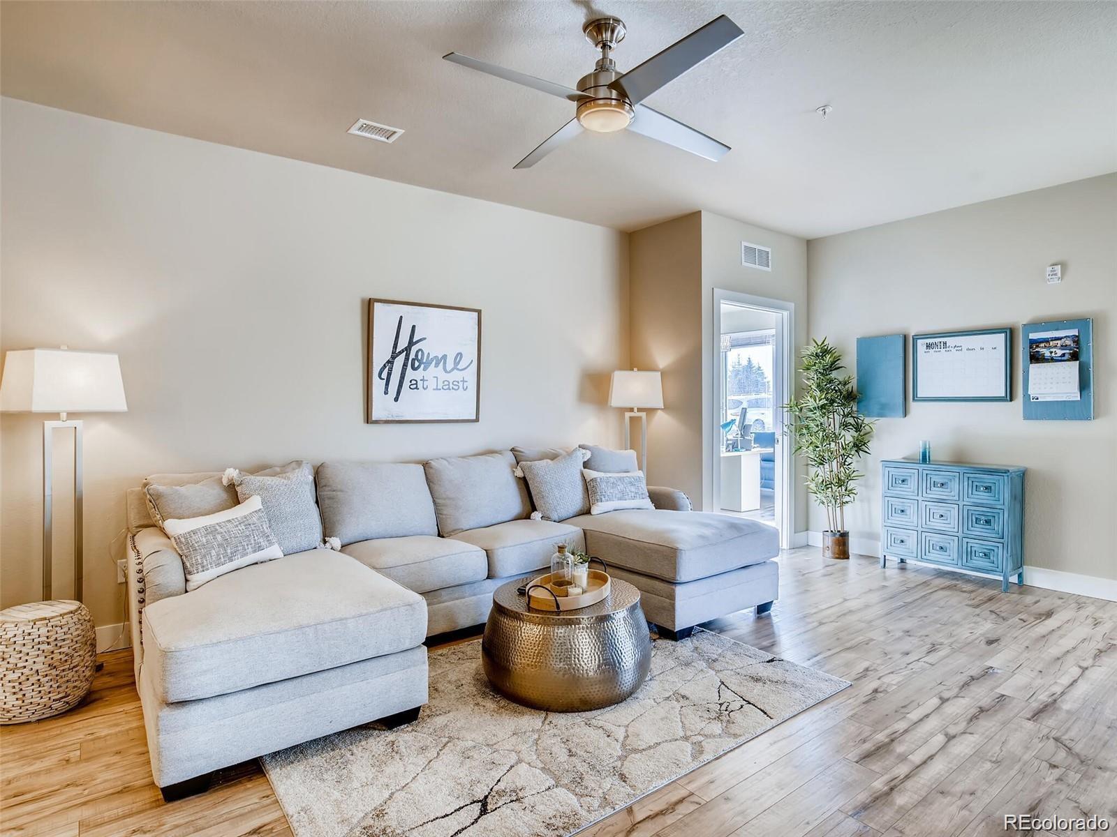15274 West 64th Lane, Unit 107 Arvada, CO 80007 - Photo 5 of 24 a living room with furniture and a couch