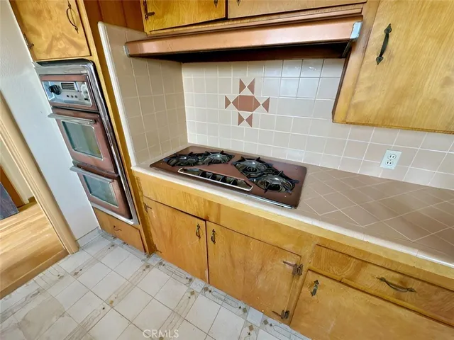 a close view of stove and cabinets