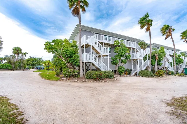 a view of a palm trees front of a house