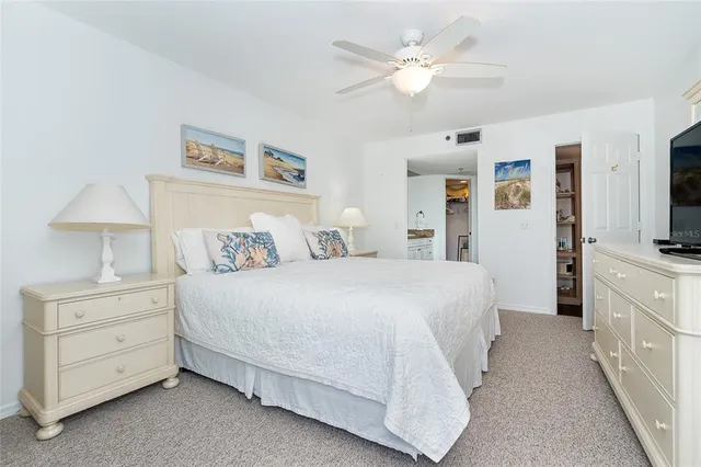 a bedroom with a large bed and a tv