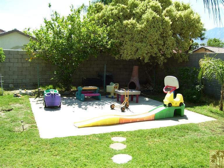 68325 Encinitas Road Cathedral City, CA 92234 - Photo 19 of 20 a view of a backyard with table and chairs potted plants and a palm tree