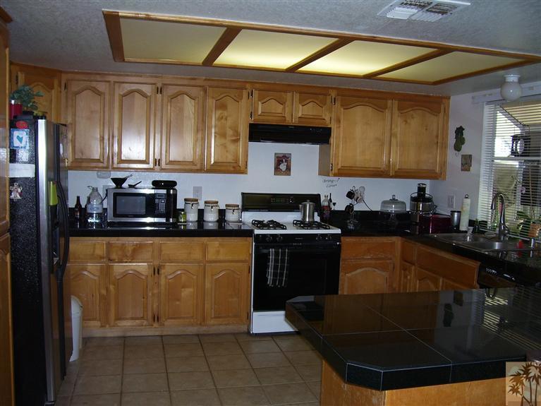 68325 Encinitas Road Cathedral City, CA 92234 - Photo 10 of 20 a kitchen with granite countertop a sink and a stove top oven