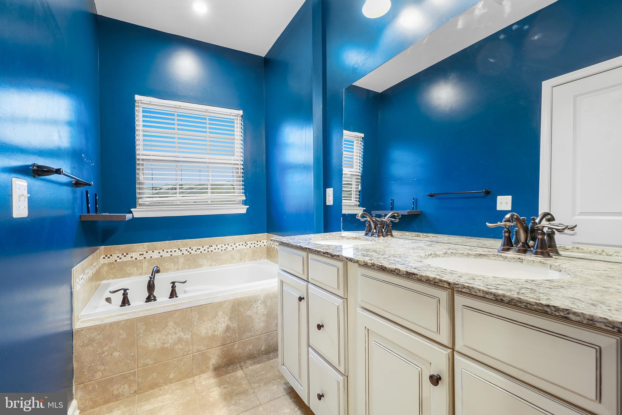 2011 Serviceberry Road Dumfries, VA 22026 - Photo 11 of 25 a bathroom with a tub sink and mirror