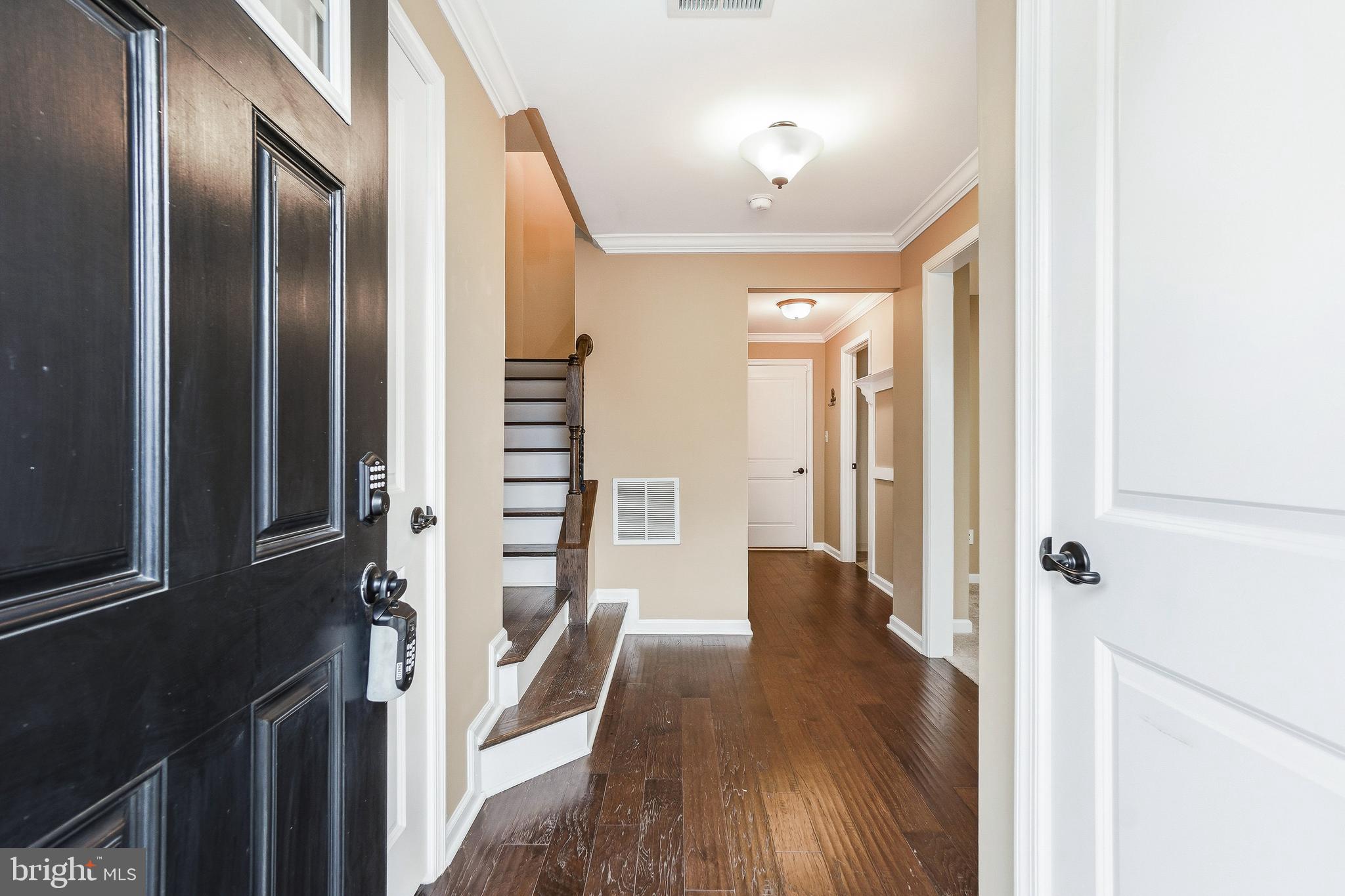2011 Serviceberry Road Dumfries, VA 22026 - Photo 21 of 25 a view of a hallway with wooden floor and staircase