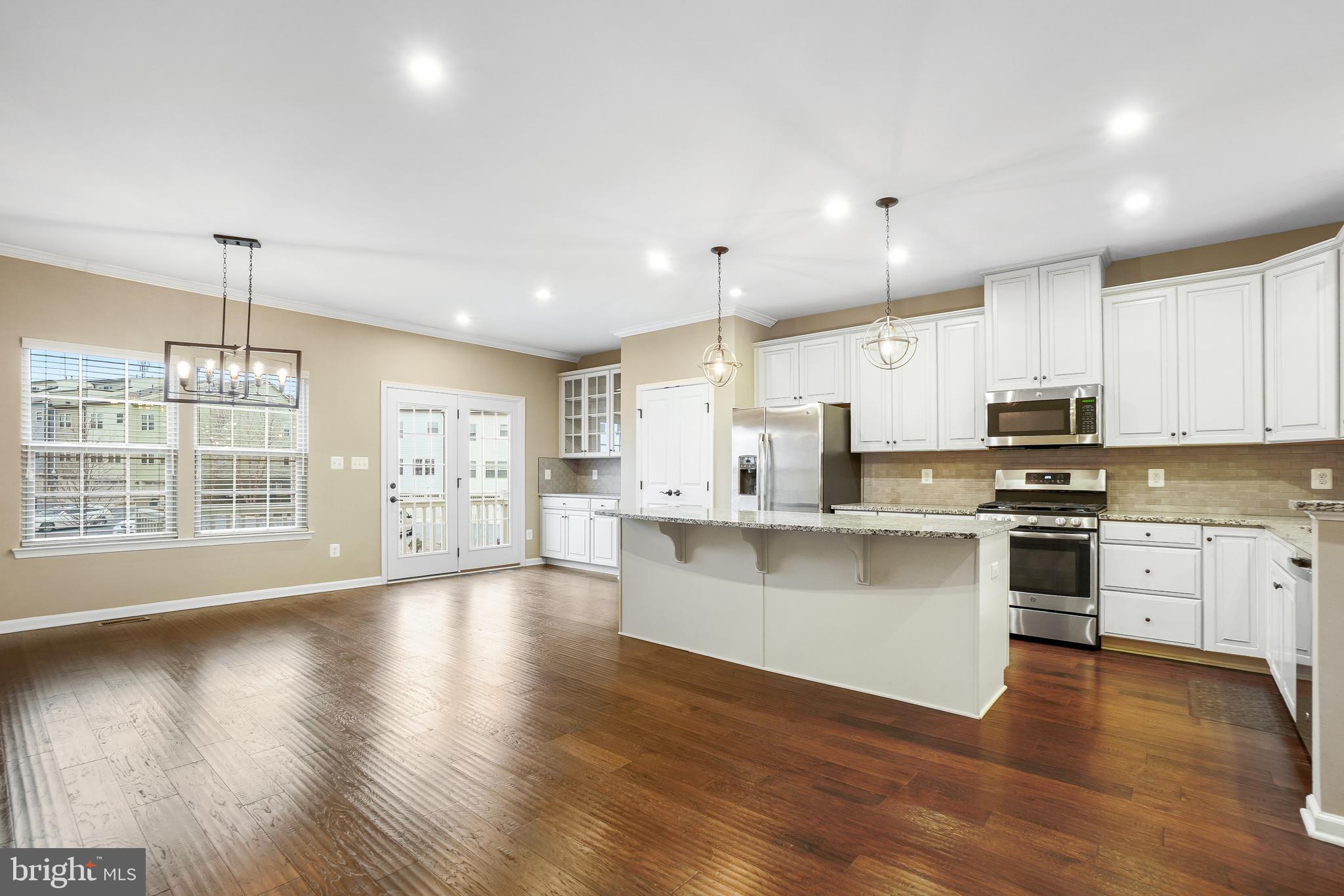 2011 Serviceberry Road Dumfries, VA 22026 - Photo 4 of 25 a view of kitchen with granite countertop a stove top oven a sink a counter space and cabinets