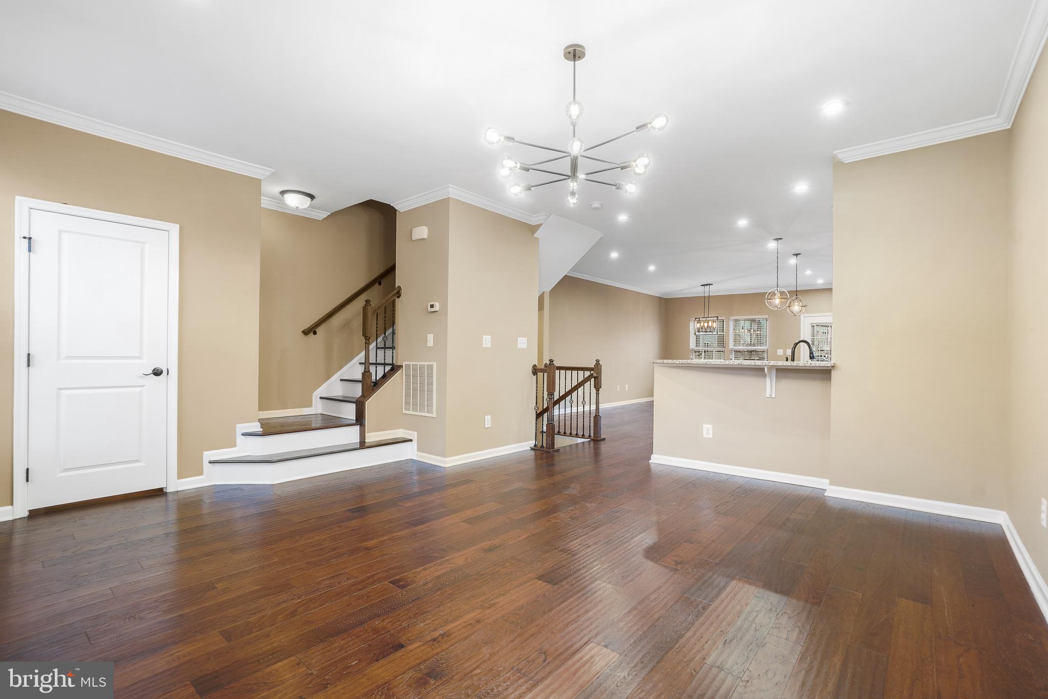 2011 Serviceberry Road Dumfries, VA 22026 - Photo 7 of 25 a view of a room with wooden floor stairs and a chandelier
