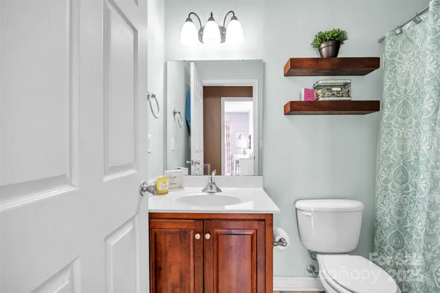 a bathroom with a toilet sink and mirror