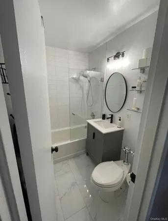 a bathroom with a toilet a sink and mirror