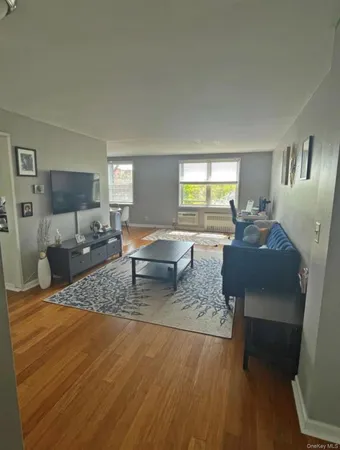 a living room with furniture and a mirror