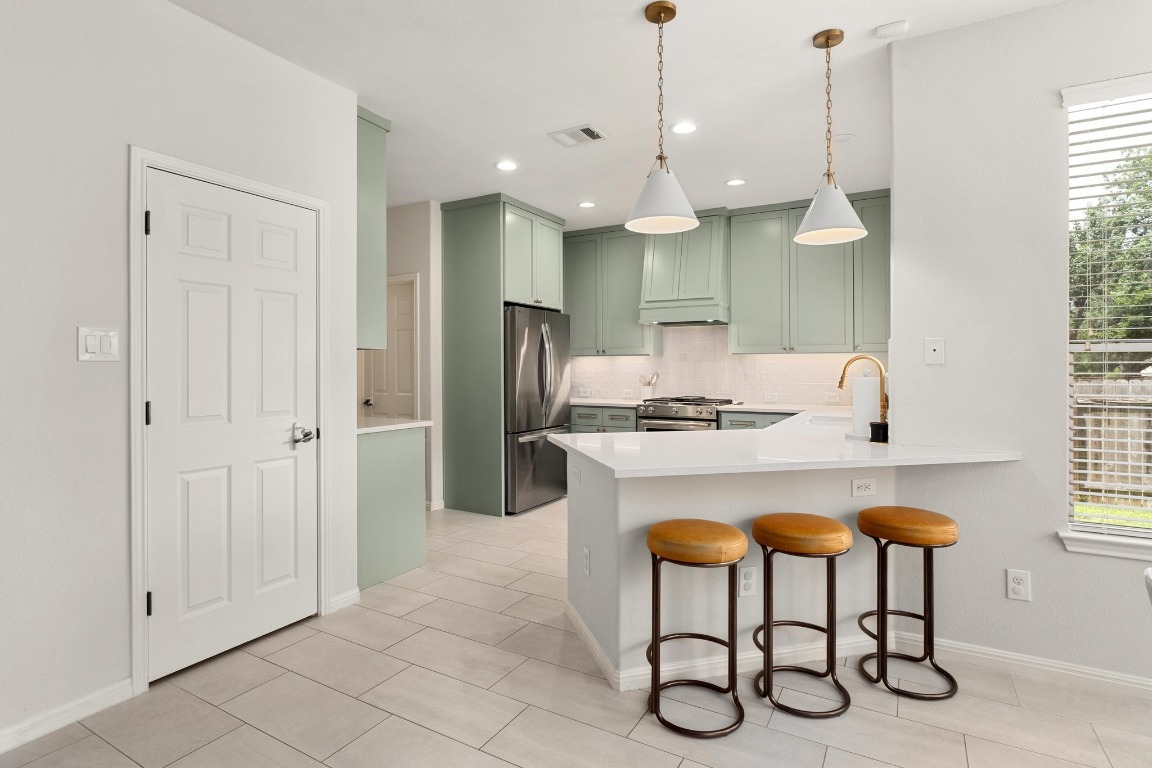5701 Sunset Ridge Austin, TX 78735 - Photo 1 of 1 a kitchen with stainless steel appliances granite countertop a sink a stove a refrigerator and island