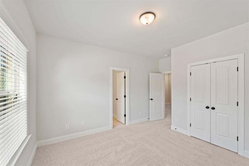 3264 Lions Ruby Lane Atlanta, GA 30349 - Photo 16 of 29 an empty room with windows and closet