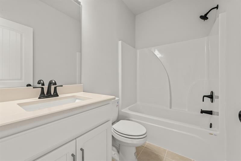 3264 Lions Ruby Lane Atlanta, GA 30349 - Photo 17 of 29 a bathroom with a sink a toilet and a bathtub