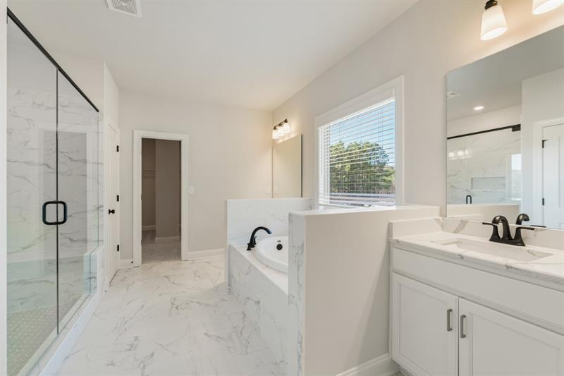 3264 Lions Ruby Lane Atlanta, GA 30349 - Photo 19 of 29 a bathroom with a shower sink and mirror