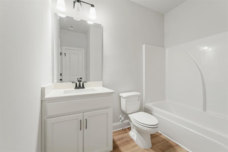 3264 Lions Ruby Lane Atlanta, GA 30349 - Photo 20 of 29 a bathroom with a sink a toilet and shower