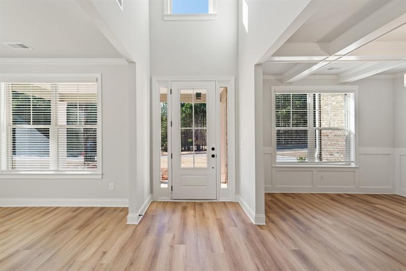 3264 Lions Ruby Lane Atlanta, GA 30349 - Photo 4 of 29 an empty room with wooden floor and windows
