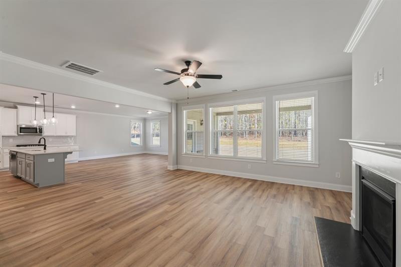 3264 Lions Ruby Lane Atlanta, GA 30349 - Photo 9 of 29 a view of an empty room with wooden floor and a window