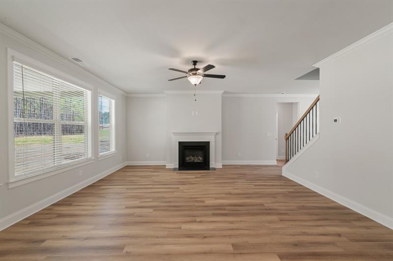 3264 Lions Ruby Lane Atlanta, GA 30349 - Photo 10 of 29 a view of an empty room with wooden floor and a window