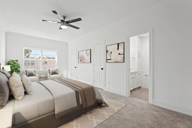 a spacious bedroom with a bed and a chandelier