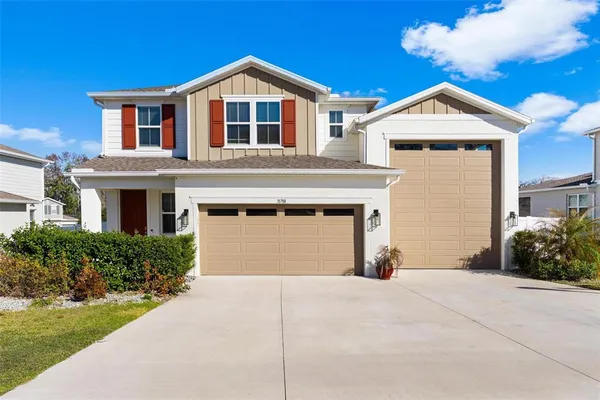 a front view of a house with a yard and garage