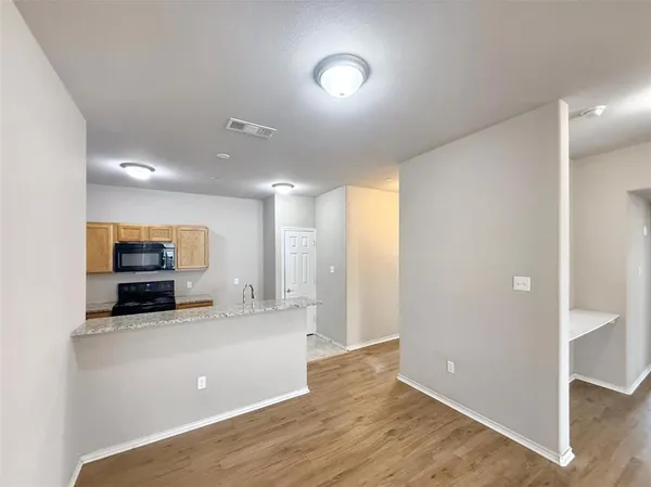 a view of a kitchen with a sink and cabinets