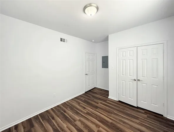 a view of a room with wooden floor