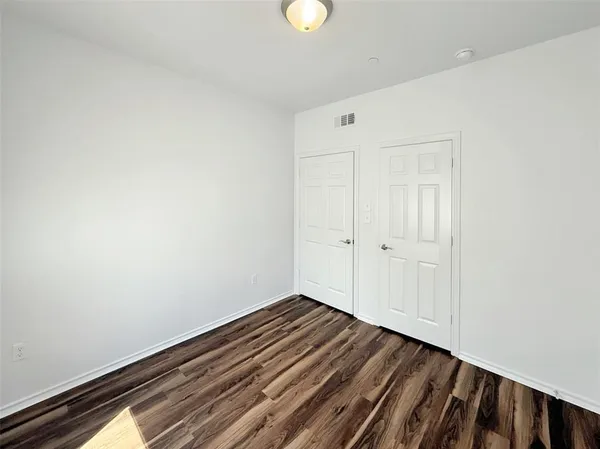 a view of room with wooden floor