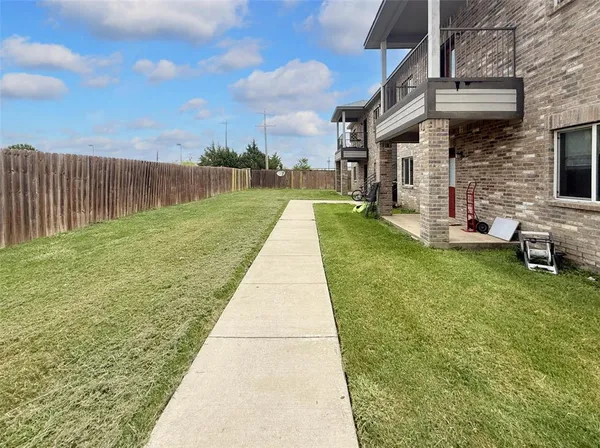a view of a backyard of the apartment