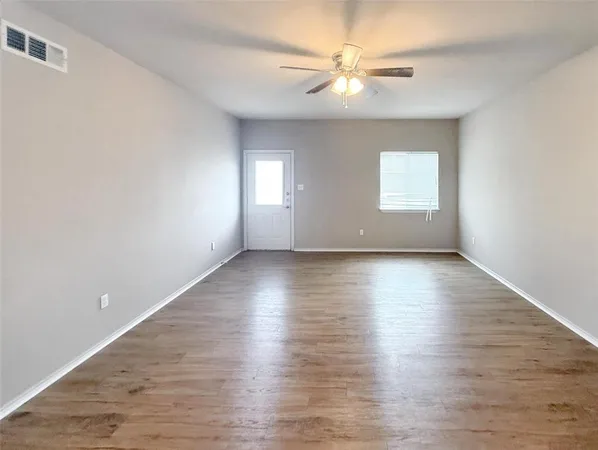 wooden floor in an empty room with a window