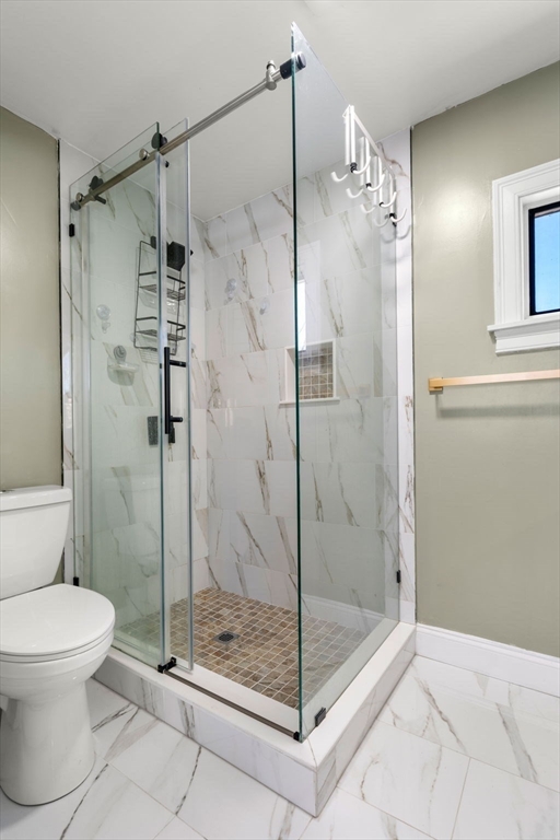 271 Broadway Haverhill, MA 01832 - Photo 18 of 41 a bathroom with a shower a toilet and a glass window