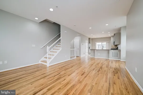 a view of empty room with wooden floor