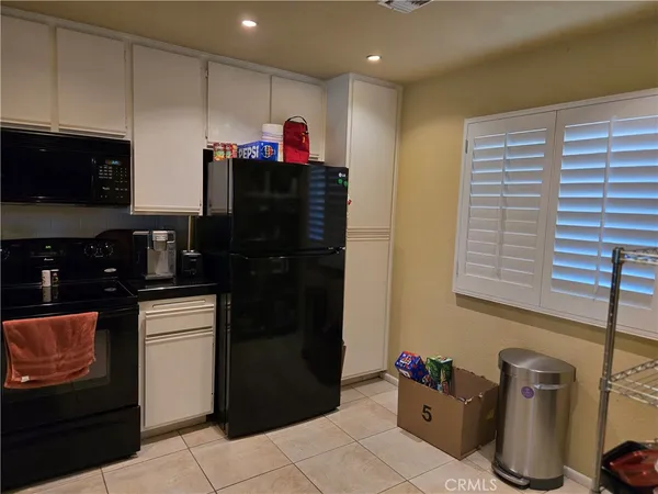 a refrigerator with a sink and cabinets
