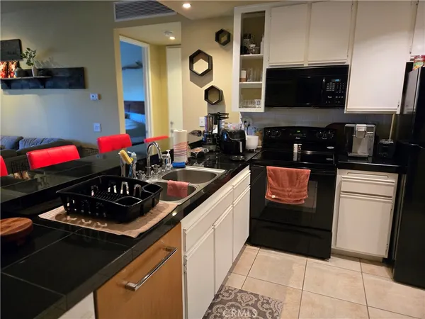 a kitchen with a sink stove and microwave
