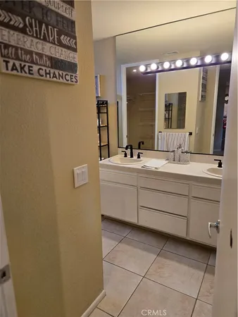 a bathroom with a sink vanity and mirror